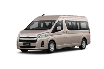 Toyota Hiace Premio Luxury coklat muda metallic tampak serong depan dan samping untuk layanan sewa Hiace Luxury Jakarta dengan driver profesional